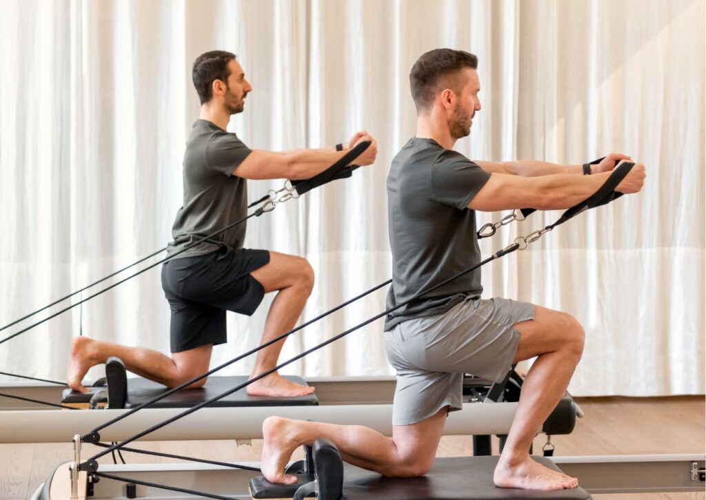 三島市のピラティススタジオでインストラクターが男性客にパーソナル指導しているシーン